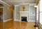 Great Room - Hardwood Floors - Built-in Bookcases - Fireplace - Custom Shutters